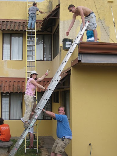 Shelly and students repairing a house